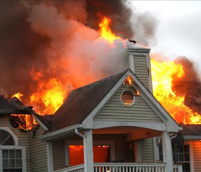 A house with the roof on fire.